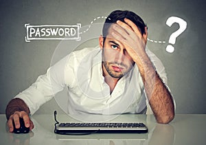 Desperate young man trying to log into his computer forgot password photo