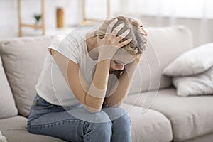 Desperate young woman suffering from loneliness at home