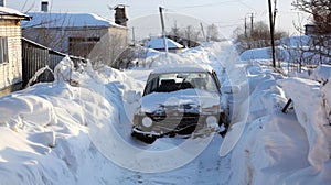 Despite efforts to clear the roads abandoned cars remain buried under the snowdrifts