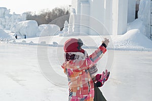 Taking selfies - woman outstretched hand taking photo at harbin snow festival freezing cold photo
