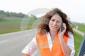 Despondent female driver trying to summon help photo