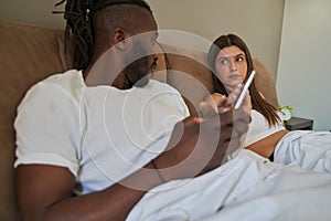 Despondent female taking away cellphone from man