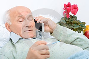 Despondent weary aged man calls up his relatives photo