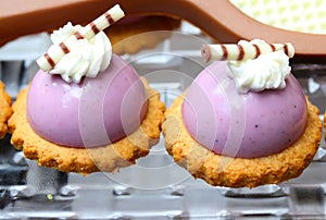 Dessert appetizers made with lavender covered ice cream on a cookie wafer