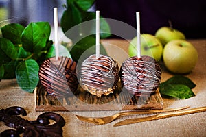 Dessert, an apple dipped in chocolate on a stick