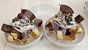 Dessert banana split: chocolate ice cream, with banana, waffle powder and nuts