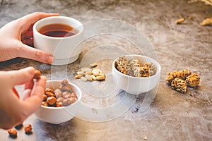 Dessert bars made of sunflower seeds  in a honey caramel. Gozinak, Caramelized peanuts in white bowl and on gray background..The