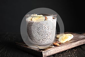 Dessert bowl of tasty chia seed pudding with banana and nuts served