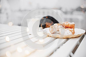 Dessert buns and a cup of coffee on a street cafe table