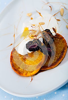 Dessert with caramelized oranges, yogurt, brambleberries photo