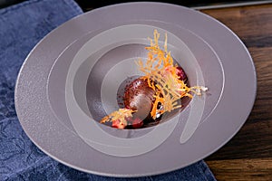 Dessert with chocolate cream and baked apple. French cuisine. The work of a professional chef. Dish from a restaurant or cafe menu