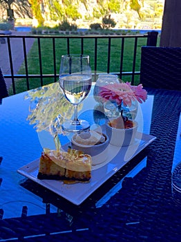 Dessert, Glass of Water and a Flower on the Table with a View