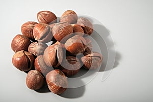 Dessert hazelnuts boiled in vanilla syrup, with cracked nutshell, gray background with copy space