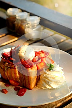 Dessert honey toast with ice cream and strawberry for romantic sweet time in valentine`s day