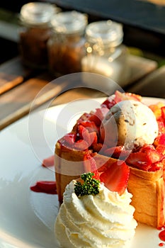 Dessert honey toast with ice cream and strawberry for romantic sweet time in valentine`s day