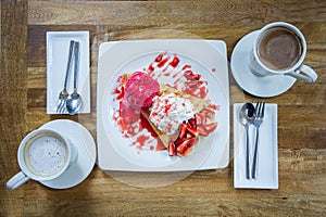 Dessert ice cream strawberry crepe and hot drink in coffee shop