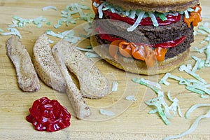 Dessert impostor cheeseburger and apple fries on cutting board