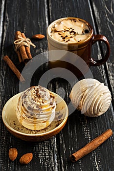 Dessert marshmallow is honeyed and sprinkled with nuts with a cup of coffee.