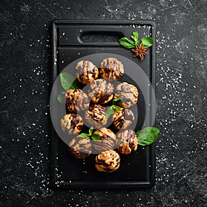 Dessert. Mini eclairs with chocolate. Baking.