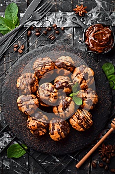 Dessert. Mini eclairs with chocolate. Baking.