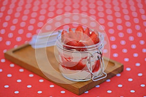 Dessert panna cotta with fresh strawberries served in a glass, selective focus. Delicious fruit creamy dessert