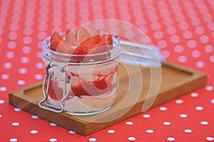 Dessert panna cotta with fresh strawberries served in a glass, selective focus. Delicious fruit creamy dessert