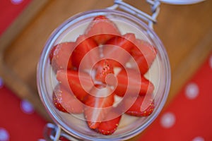 Dessert panna cotta with fresh strawberries served in a glass, selective focus. Delicious fruit creamy dessert