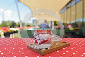 Dessert panna cotta with fresh strawberries served in a glass, selective focus. Delicious fruit creamy dessert