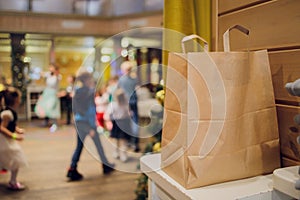 dessert paper bag waiting for customer on counter in modern cafe coffee shop, food delivery, cafe restaurant, takeaway