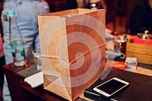 dessert paper bag waiting for customer on counter in modern cafe coffee shop, food delivery, cafe restaurant, takeaway