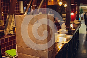 dessert paper bag waiting for customer on counter in modern cafe coffee shop, food delivery, cafe restaurant, takeaway