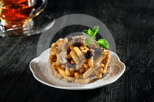 Dessert plate and cups on black background