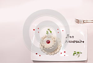 Dessert plate with Happy birthday in french written in chocolate.