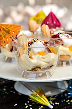 Dessert with pudding, biscuits and fruit in a glass