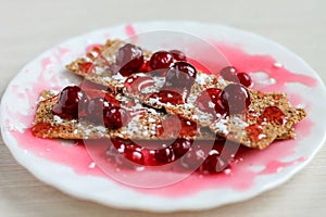 Dessert with red berries, on a white plate, close up