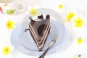 Dessert snack chocolate cake delicious and cup coffee with flower frangipani