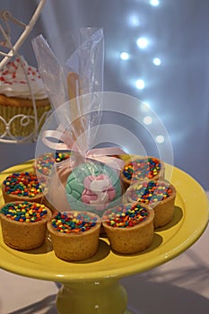 Dessert stand. Homemade candies party, colorful sugar dots. Bokeh light background