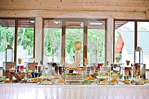 Dessert table of delicious snacks on wedding reception