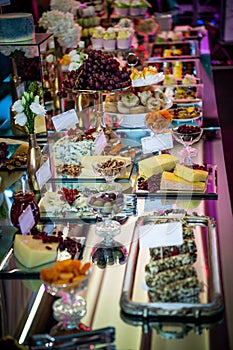 Dessert table for a party. Candy bar and cheese bar. Rich thematic wedding candy bar high variety of sweets