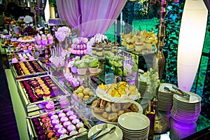 Dessert table for a party. Candy bar. Rich thematic wedding candy bar high variety of sweets