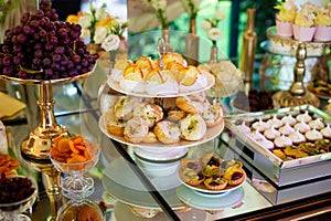 Dessert table for a party. Candy bar. Rich thematic wedding candy bar high variety of sweets