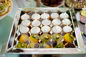 Dessert table for a party. Candy bar. Rich thematic wedding candy bar high variety of sweets