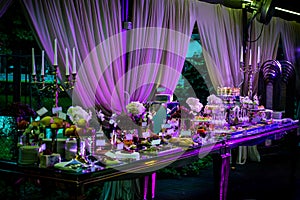 Dessert table for a party. Candy bar. Rich thematic wedding candy bar high variety of sweets