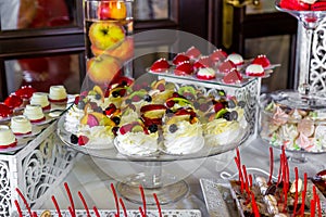 Dessert table for a party. Ombre cake, cupcakes. Candy bar