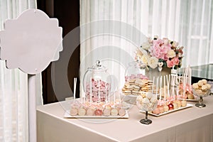 Dessert table for a party. Ombre cake, cupcakes, sweetness and flowers. Wedding decorations