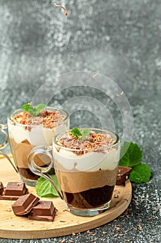 Dessert three chocolates with mint on a light background. Layered delicious dessert. vertical image. place for text