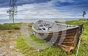 Desserted old boat in a stunning sea coastline with beautiful landscape and panoromic view with horizon