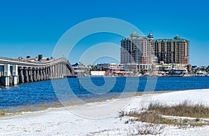 Destin, Florida - February 13, 2016: Bridge to Destin and city hotels under a blue winter sky