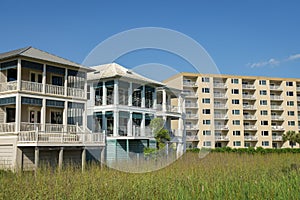 Destin, Florida- View of three-storey houses with view deck and apartment building with balconies