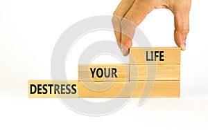 Destress your life symbol. Concept words Destress your life on wooden blocks. Doctor hand. Beautiful white table white background